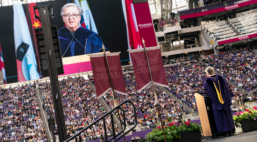 Karen Kaivola speaking at graduation in U.S. Bank Stadium 2019